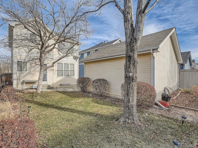 rear view of house featuring a yard