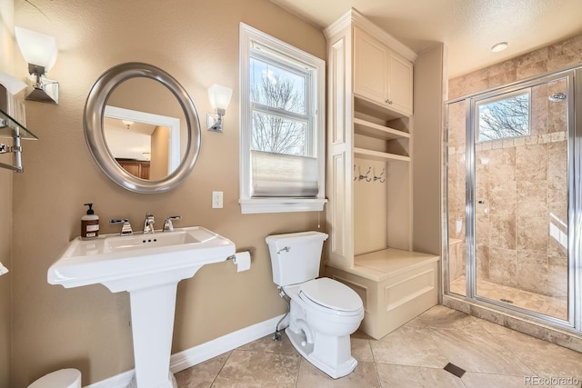 full bath featuring toilet, a stall shower, baseboards, and a wealth of natural light