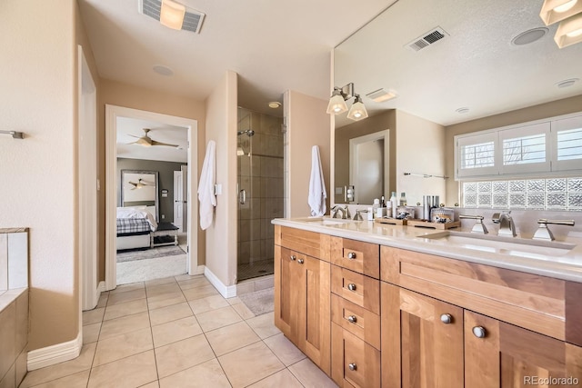 full bath featuring tile patterned flooring, visible vents, a sink, and a shower stall