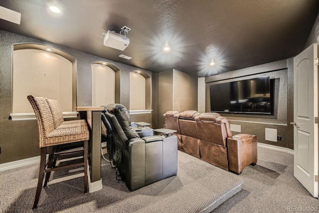 cinema room with carpet floors, recessed lighting, baseboards, and a textured wall