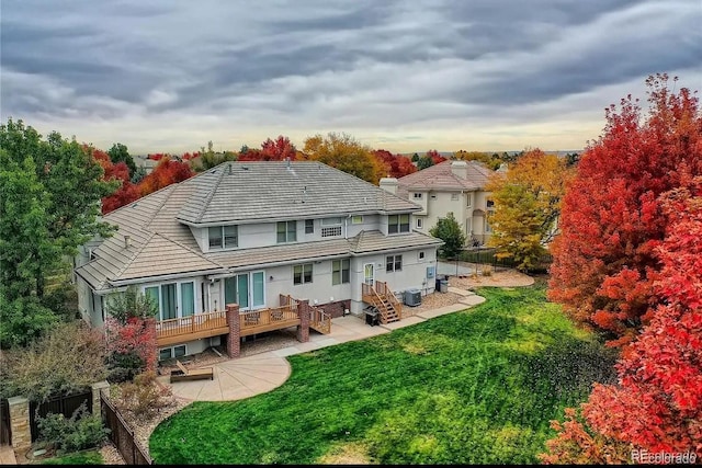 back of property with a lawn, a patio, fence, cooling unit, and stucco siding