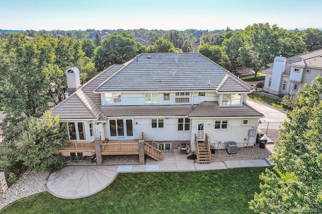 6790 W Crestline Ave, Littleton, CO 80123 - back of property with a chimney, stucco siding, a deck, and a patio