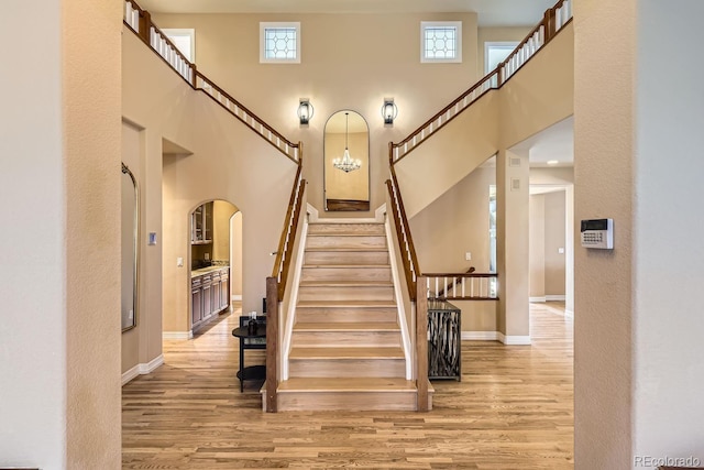 6790 W Crestline Ave, Littleton, CO 80123 - stairway featuring wood finished floors, baseboards, a towering ceiling, and healthy amount of natural light