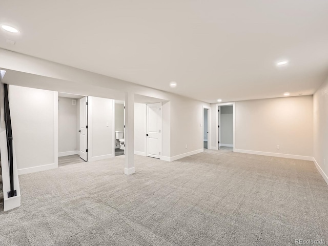 basement featuring light carpet