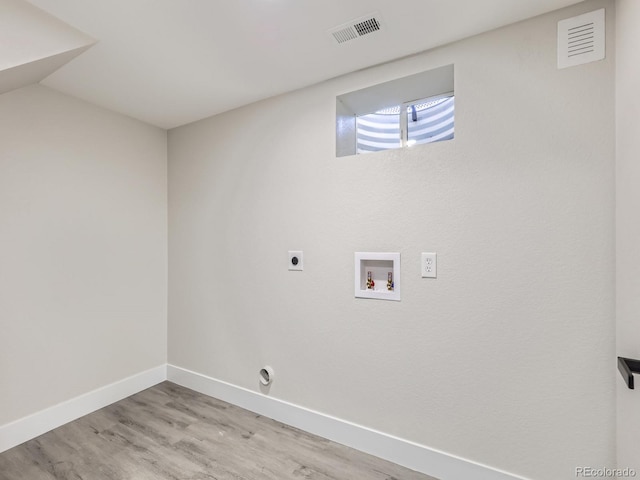 laundry room featuring washer hookup, light hardwood / wood-style floors, and electric dryer hookup