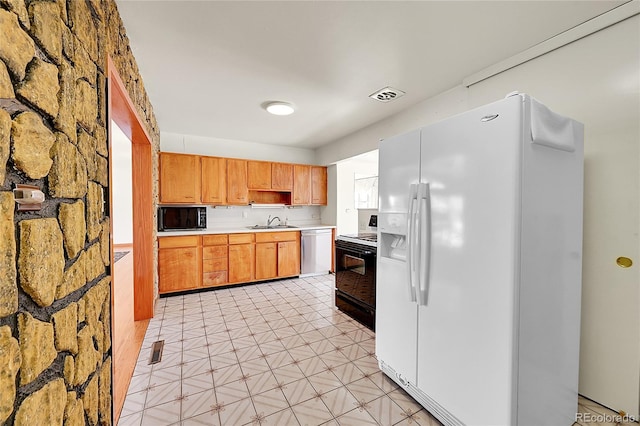 5621 Demott Ave, Commerce City, CO 80022 - kitchen with range with electric cooktop, white refrigerator with ice dispenser, sink, and dishwasher