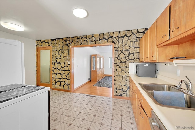 5621 Demott Ave, Commerce City, CO 80022 - kitchen with dishwashing machine, sink, and white stove