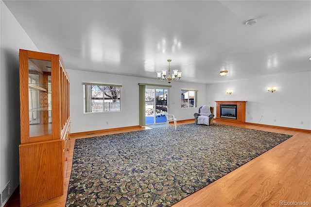 5621 Demott Ave, Commerce City, CO 80022 - living room with an inviting chandelier and hardwood / wood-style floors
