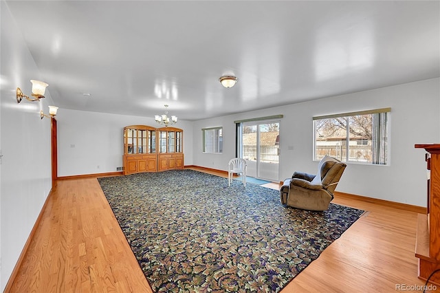 5621 Demott Ave, Commerce City, CO 80022 - living room with hardwood / wood-style floors and a chandelier