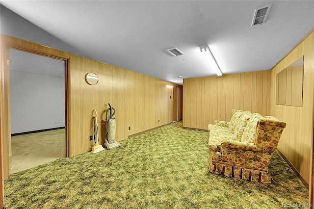 5621 Demott Ave, Commerce City, CO 80022 - sitting room featuring light colored carpet and wood walls