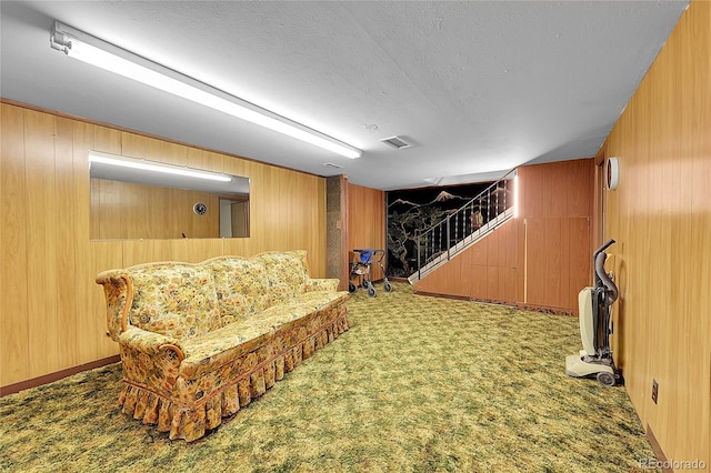 5621 Demott Ave, Commerce City, CO 80022 - living area with wooden walls, carpet floors, and a textured ceiling