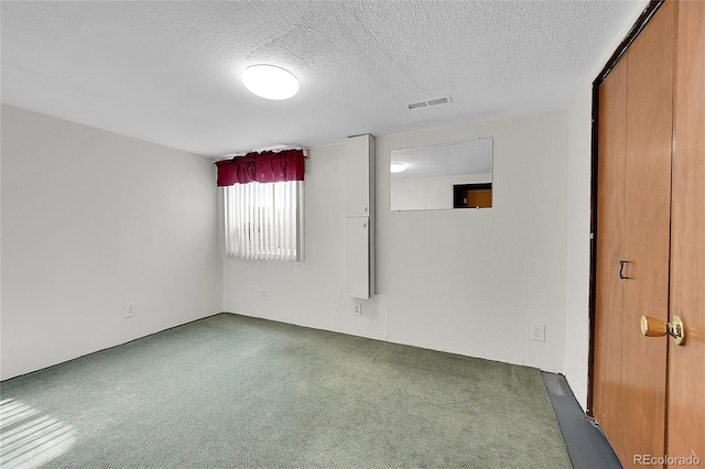 5621 Demott Ave, Commerce City, CO 80022 - carpeted empty room featuring a textured ceiling