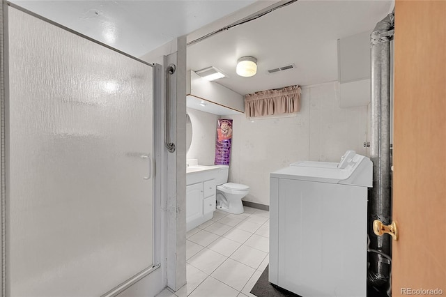 5621 Demott Ave, Commerce City, CO 80022 - bathroom featuring washer / clothes dryer, vanity, an enclosed shower, toilet, and tile patterned floors