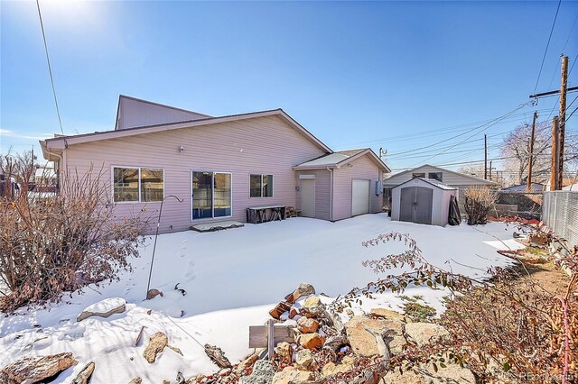 5621 Demott Ave, Commerce City, CO 80022 - snow covered property featuring a storage unit