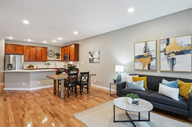 3482 E 28th Ave, Denver, CO 80205 - living area featuring light wood finished floors, recessed lighting, and baseboards