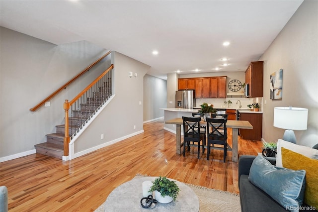 3482 E 28th Ave, Denver, CO 80205 - living area with stairway, light wood-style floors, recessed lighting, and baseboards