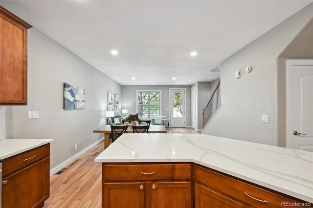3482 E 28th Ave, Denver, CO 80205 - kitchen featuring light wood-style flooring, open floor plan, baseboards, light stone countertops, and recessed lighting