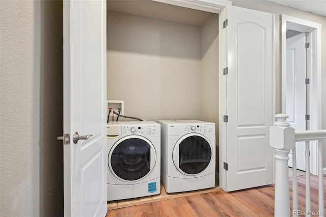 3482 E 28th Ave, Denver, CO 80205 - laundry room with light wood-type flooring and separate washer and dryer