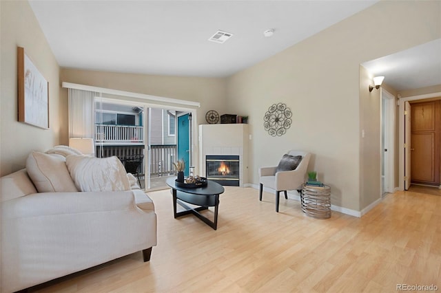 living room featuring a fireplace and light hardwood / wood-style floors