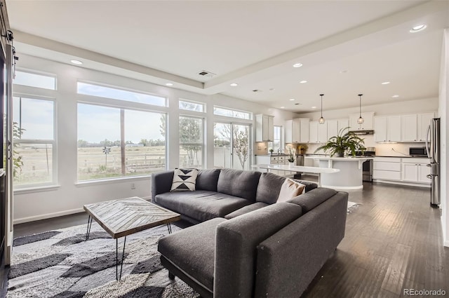 5010 Eaglewood Ln, Johnstown, CO 80534 - living area featuring healthy amount of natural light, recessed lighting, and dark wood-style flooring
