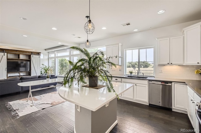 5010 Eaglewood Ln, Johnstown, CO 80534 - kitchen featuring stainless steel dishwasher, open floor plan, tasteful backsplash, white cabinets, and recessed lighting