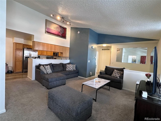 carpeted living area featuring baseboards, visible vents, rail lighting, a textured ceiling, and high vaulted ceiling