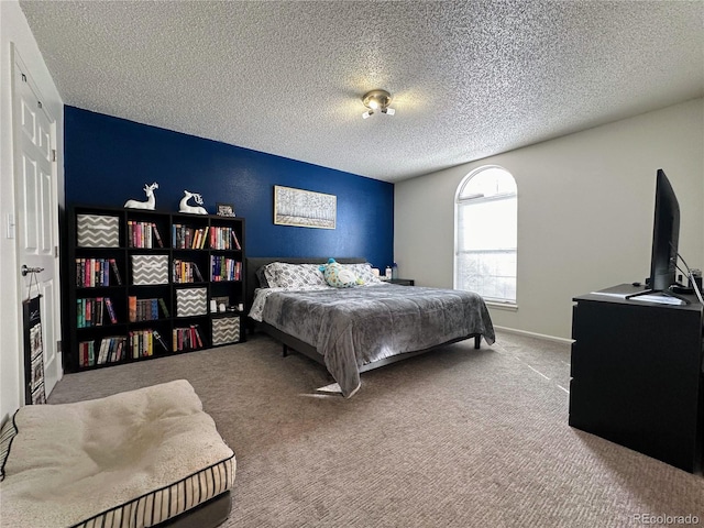 bedroom with carpet floors, a textured ceiling, and baseboards