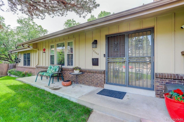 8866 E Easter Ave, Centennial, CO 80112 - entrance to property with board and batten siding, brick siding, and a porch