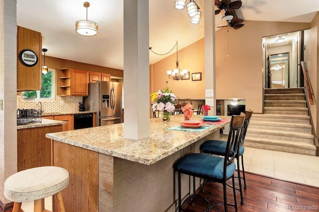 8866 E Easter Ave, Centennial, CO 80112 - kitchen featuring stainless steel fridge with ice dispenser, brown cabinetry, a ceiling fan, black dishwasher, and vaulted ceiling