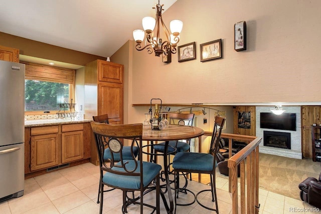8866 E Easter Ave, Centennial, CO 80112 - dining space featuring light tile patterned floors, a large fireplace, a chandelier, and lofted ceiling