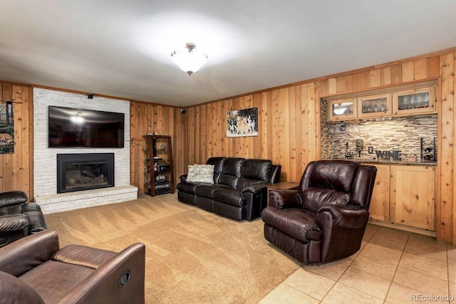 8866 E Easter Ave, Centennial, CO 80112 - living room with wooden walls, a fireplace, light tile patterned floors, crown molding, and light colored carpet