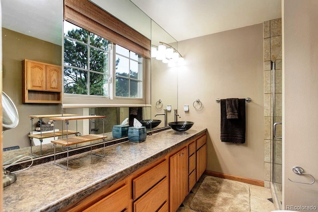 8866 E Easter Ave, Centennial, CO 80112 - bathroom featuring double vanity, a shower with door, and baseboards