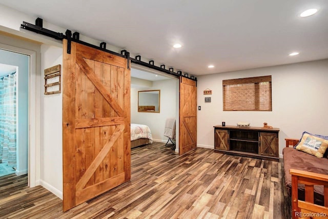 8866 E Easter Ave, Centennial, CO 80112 - hall with a barn door, wood finished floors, recessed lighting, and baseboards