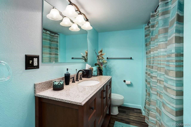 8866 E Easter Ave, Centennial, CO 80112 - full bath with vanity, toilet, a chandelier, wood finished floors, and baseboards