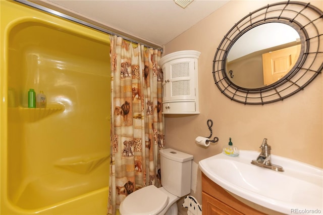 bathroom featuring vanity, a shower with shower curtain, and toilet