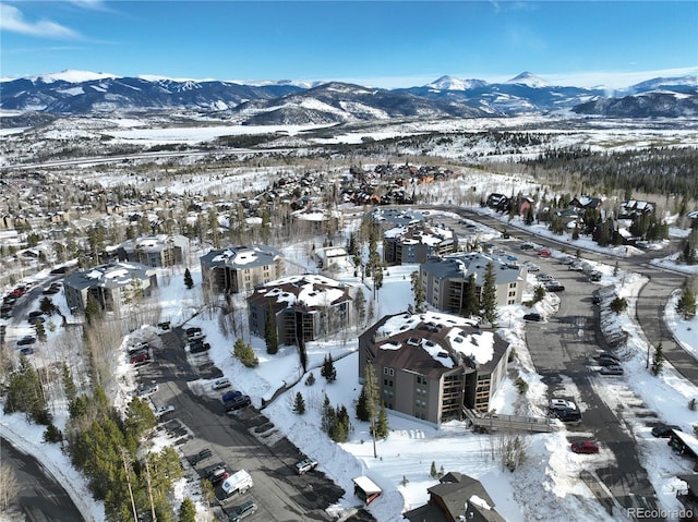 snowy aerial view featuring a mountain view