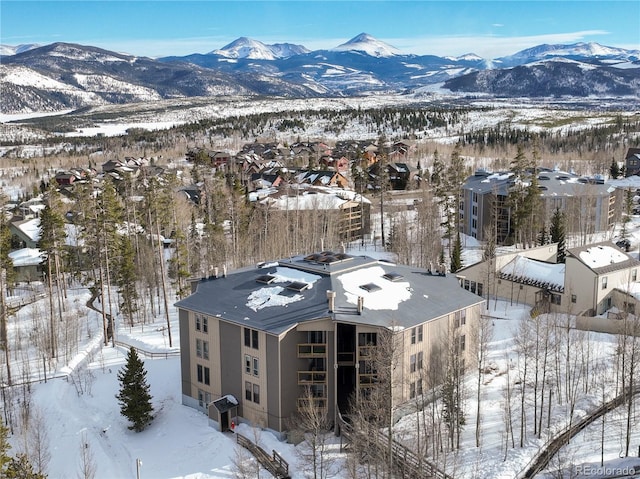 snowy aerial view with a mountain view