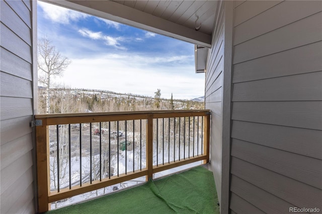 view of snow covered back of property