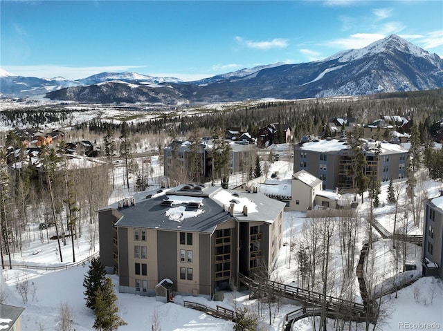 snowy aerial view with a mountain view