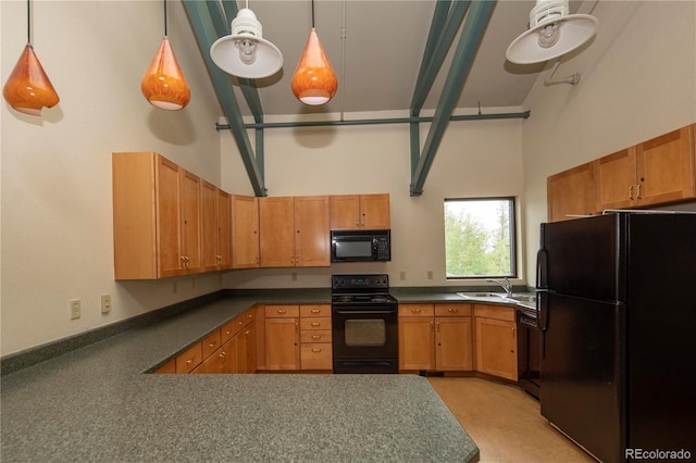 kitchen featuring sink, hanging light fixtures, a high ceiling, black appliances, and kitchen peninsula