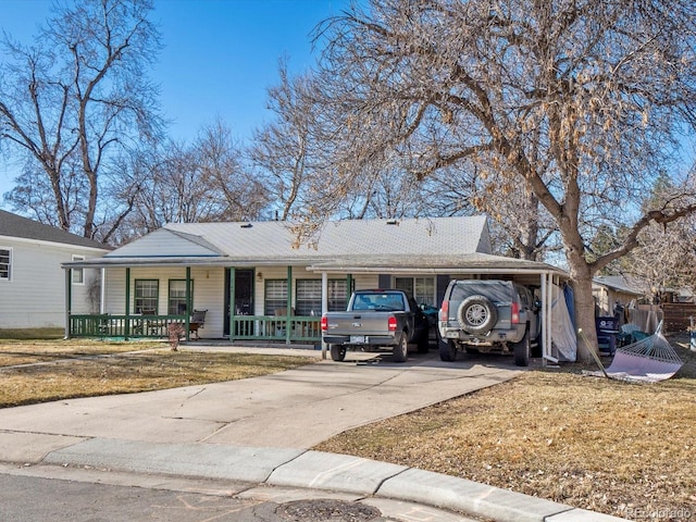 single story home with a porch, a carport, and a front yard