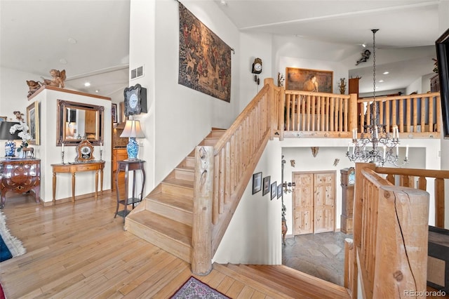 32209 Blue Springs Dr, Evergreen, CO 80439 - staircase featuring a chandelier, wood-type flooring, recessed lighting, and high vaulted ceiling