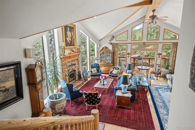 32209 Blue Springs Dr, Evergreen, CO 80439 - living area featuring a fireplace, wood finished floors, high vaulted ceiling, a ceiling fan, and beamed ceiling