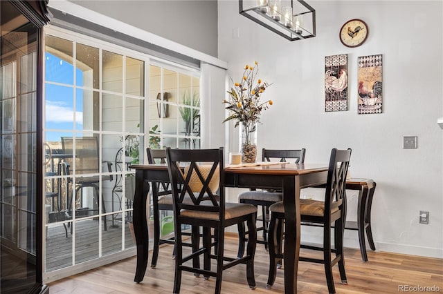 8944 Fox Dr Unit 6-103, Denver, CO 80260 - dining space featuring wood finished floors, baseboards, and a chandelier