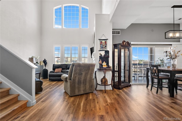 8944 Fox Dr Unit 6-103, Denver, CO 80260 - living area featuring stairs, wood finished floors, plenty of natural light, and a towering ceiling