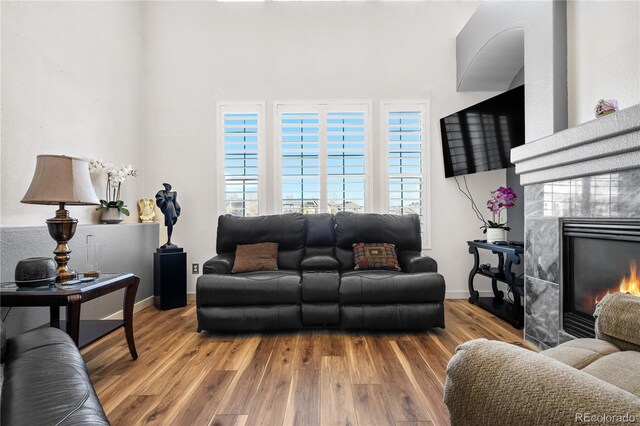 8944 Fox Dr Unit 6-103, Denver, CO 80260 - living room featuring wood finished floors, a fireplace, plenty of natural light, and baseboards