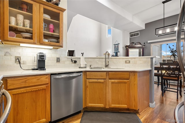 8944 Fox Dr Unit 6-103, Denver, CO 80260 - kitchen featuring dishwasher, a sink, a peninsula, decorative backsplash, and light countertops