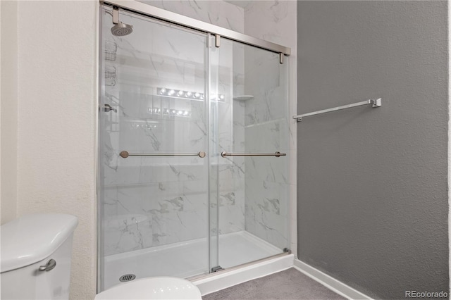 8944 Fox Dr Unit 6-103, Denver, CO 80260 - full bathroom with toilet, a textured wall, and a marble finish shower