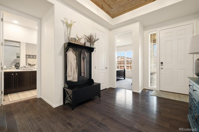 entryway with dark wood-style floors and baseboards