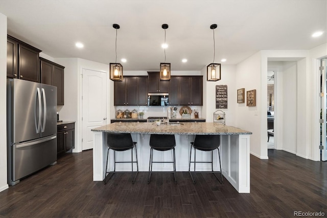 kitchen featuring stainless steel appliances, dark wood-type flooring, dark brown cabinetry, and tasteful backsplash